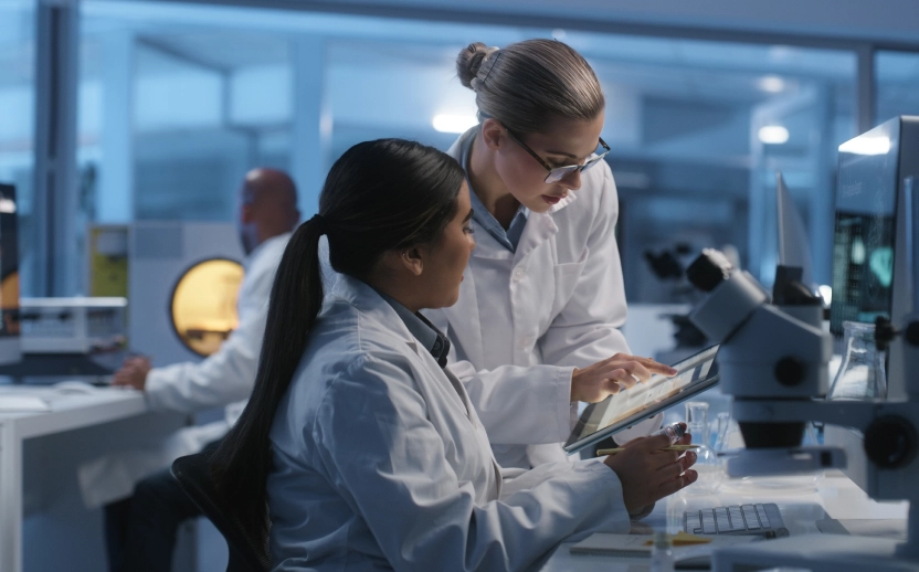 Two scientists collaborating in a laboratory, emphasizing traceability and effective team coordination.